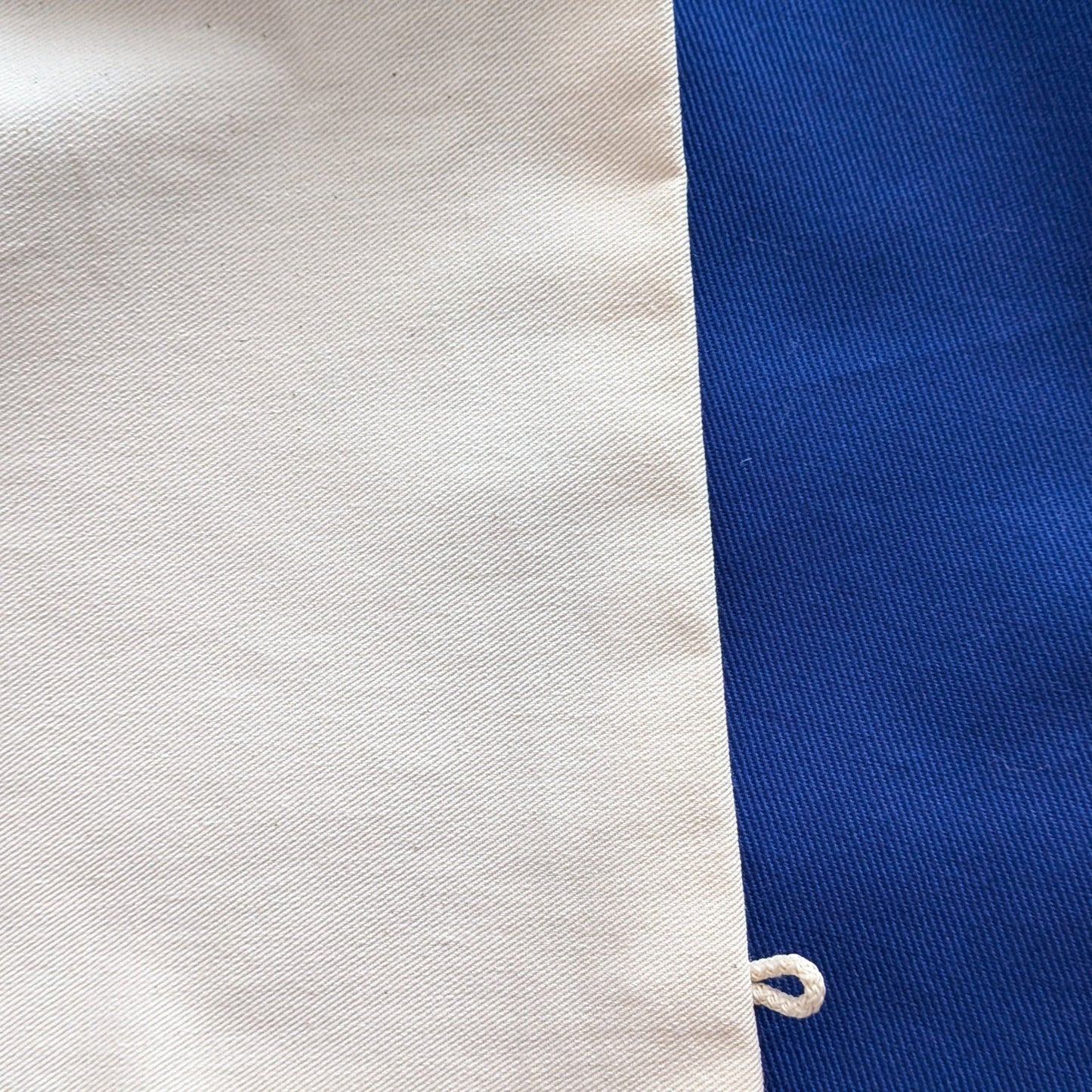 Close-up of fabric with a blue stripe and white background
