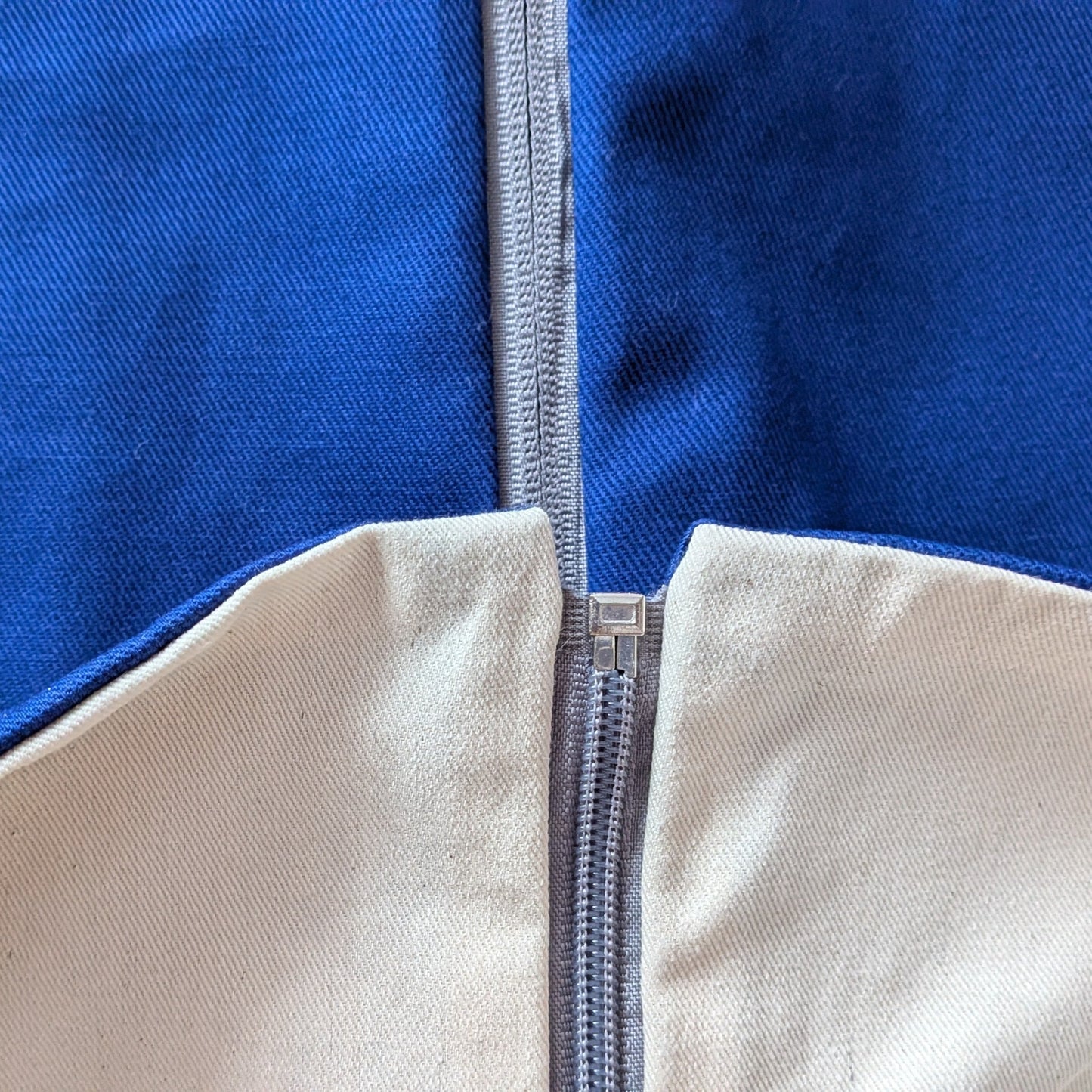 Close-up of a blue and beige fabric with a zipper