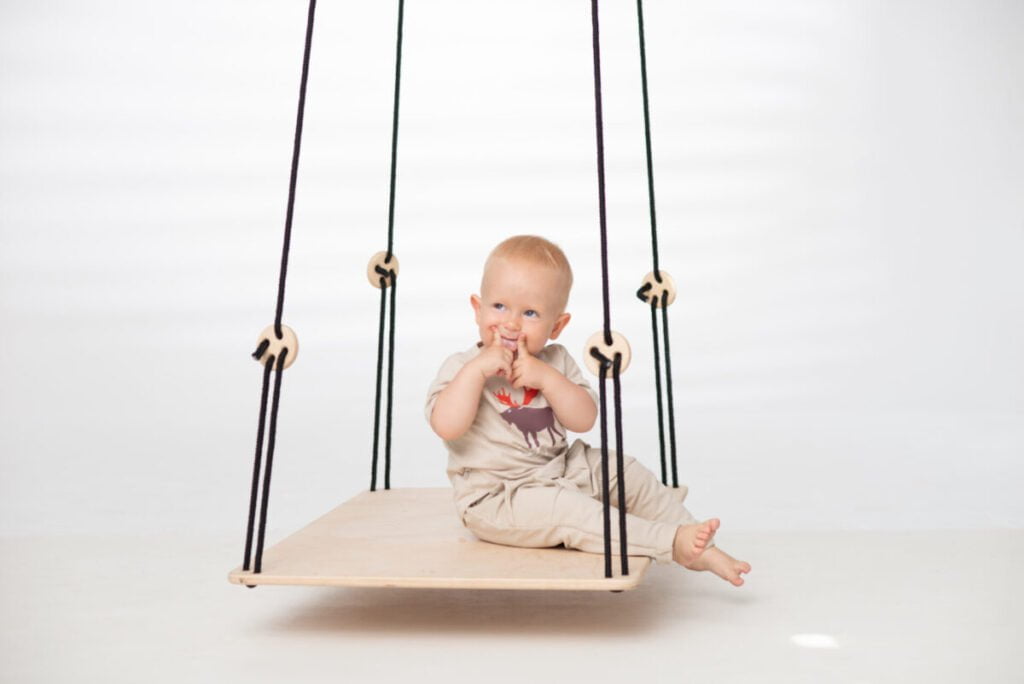 toddler sitting on SENSORY PLATFORM- GOOD WOOD 