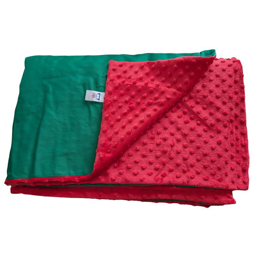 Folded green and red blanket with a visible brand label on a white background