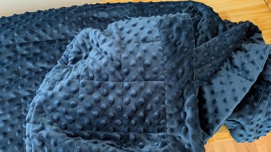 Blue textured blanket on a wooden surface